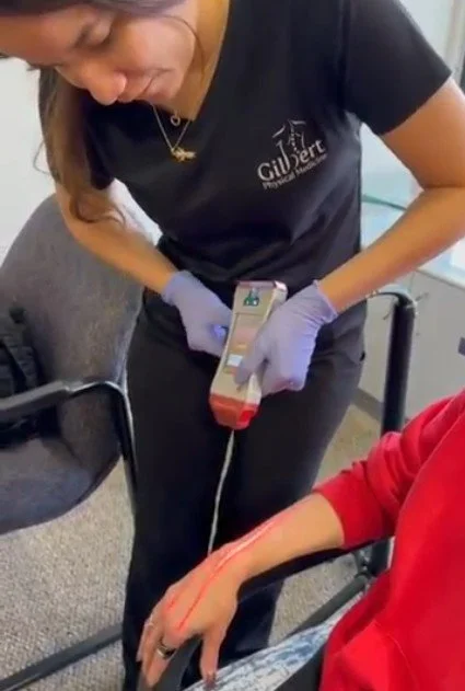 GPM team member using the current cold laser device during care.