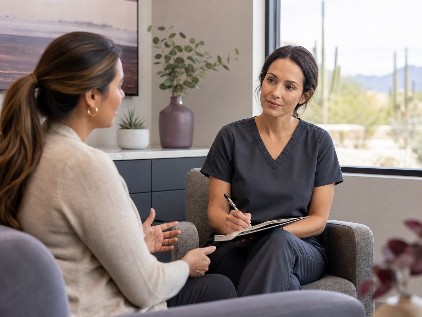 Clinician listening during a calm, non-emergency consultation.